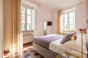 罗马G & G Maisonette Testaccio的一间卧室设有一张大床和两个窗户。