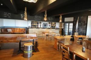 LaideOcean View Bar & Rooms的一间带木桌椅的餐厅和一间酒吧