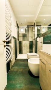 佩萨罗Hotel Vienna的浴室配有2个盥洗盆、卫生间和淋浴。