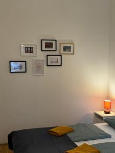 布达佩斯Maria Suite的卧室配有一张床,墙上挂有图片