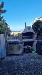 瓦尔帕莱索Casa 2h 2b con patio y quincho的后院设有木制烧烤架和围栏