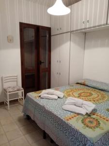 兰佩杜萨Splendido appartamento a Lampedusa, con terrazzo !的一间卧室配有一张床,上面有两条毛巾