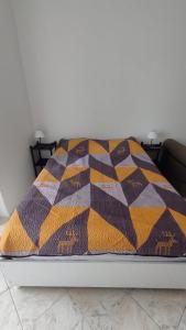 圣维森特岛Studio com bela vista para o mar的床上有五颜六色的毯子