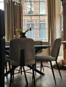 吕伐登City House Grande Madame Agaath的一间带桌椅和窗户的用餐室