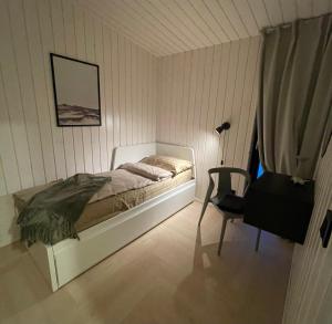 奥泰佩Tondikaku Holiday Home的一间卧室配有一张床和一把椅子