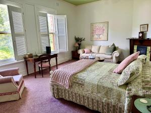 皇后镇彭哈纳住宿加早餐酒店的一间卧室配有一张床、一张沙发和一张桌子