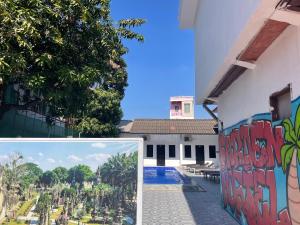 万象Vientiane Garden Hostel的一座带游泳池的建筑的侧面壁画
