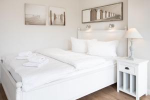 于斯德Haus Delft Lita的白色卧室内的一张白色床,配有灯