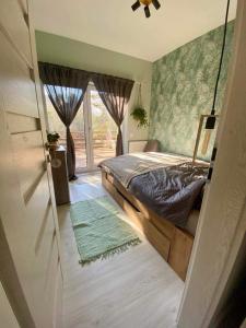 泽拜盖尼Zebikuckó的一间卧室设有一张床和一个滑动玻璃门