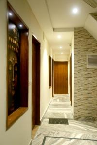 阿格拉Pyrenees Homestay的走廊上设有门,铺有瓷砖地板