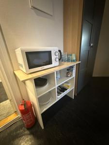 奥斯陆Center Apartments Group的配有电视和桌子上的微波炉的房间