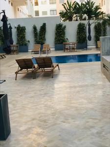 盖尼特拉Apparemment avec piscine的一座带长椅和游泳池的庭院