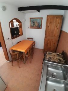 维拉卡洛斯帕兹Meraki Classic的厨房配有桌子、水槽和炉灶。