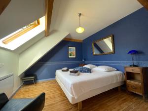 Saint-Pierre-dʼEntremontl'Ancienne Ecole du Villard的一间卧室设有一张床和蓝色的墙壁
