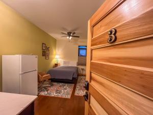 ElkaderGoldfinch Suites的带冰箱的厨房和客房内的一张床