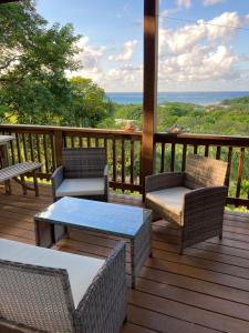 Diamond RockApartment Diamond Hill Resort的一个带桌椅的海景甲板