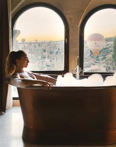 格雷梅苏丹洞穴套房酒店的坐火车的浴缸里坐着热气球的女人