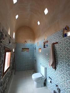 锡瓦مراقي سيوة Maraqi Siwa的浴室设有白色卫生间和蓝色瓷砖。