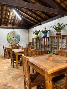 瓜佩Pousada do Lago Dutra的用餐室配有木桌和木椅