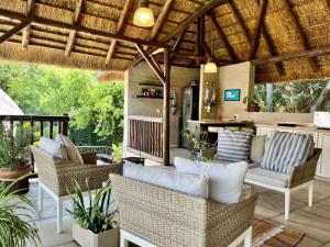SandtonMalinga GuestHouse的一个带柳条椅的户外庭院和酒吧