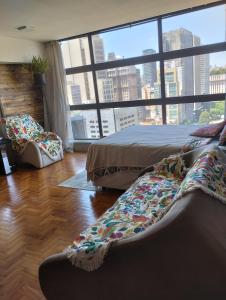 圣保罗Mirante do Vale - Centro Histórico de São Paulo的一间卧室设有一张床和一个大窗户