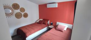 罗什福尔Charmante maison de plain-pied的卧室设有红色的墙壁和一张床