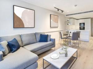 伦敦Modern Hammersmith Bridge Flat的客厅配有沙发和桌子
