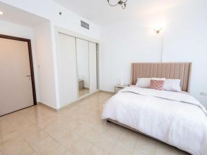 迪拜Avantha By Afi luxury 2BHK apartment的一间白色卧室,配有床和瓷砖地板