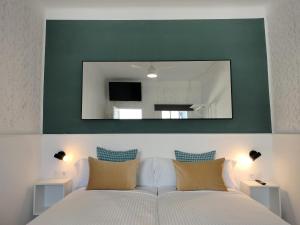 拉拉古纳Room27的卧室配有大镜子,位于床上方
