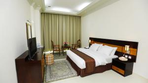 马斯喀特国际广场酒店客房内的一张或多张床位