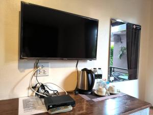 奥南海滩The Morning mini house aonang的墙上的平板电视,带遥控器