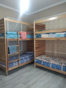 基希讷乌Buddha Hostel的客房设有三张双层床和蓝色的床。