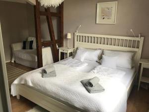 福尔巴赫Bergschlössl Herrenwies的卧室配有白色的床和2条毛巾