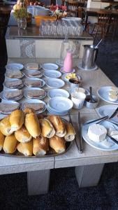 阿雷格里港罗马酒店的餐桌,盘子上放有面包和碗的食物
