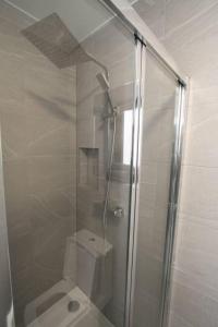 伦敦New Cosy Studio in London!的浴室设有玻璃淋浴间和卫生间