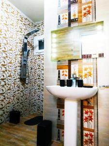 达喀尔Chambres meublées Avenue Cheikh Anta Diop的一间带水槽和淋浴的浴室