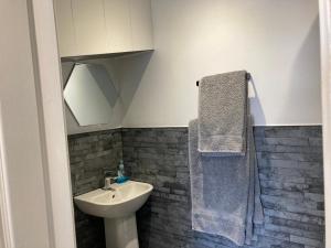 霍恩西Ashburnam Guest House的一间带水槽、卫生间和毛巾的浴室