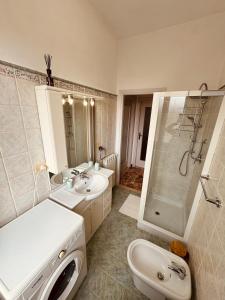 瓦拉泽Casa vacanze LA NINA的一间带两个盥洗盆、淋浴和卫生间的浴室