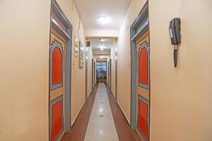 普里Hotel Ashraya的走廊上设有橙色门和长长的走廊