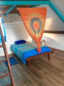 AfaahitiL'Auberge de Tahiti Iti - Beach hostel的一间设有床的房间,上面有蚊帐