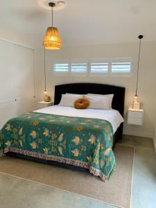 Erowal BayErowal Bay Guesthouse Jervis Bay的一间卧室配有一张带绿毯的大床