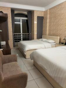 河内Roma Hotel Noi Bai airport的酒店客房,配有两张床和椅子