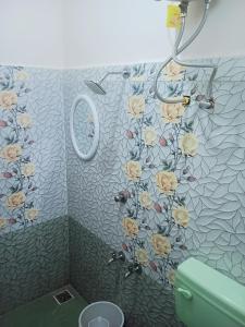 蓬蒂切里Rose Villa Pondicherry的墙上设有带鲜花淋浴的浴室