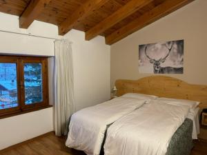 福尔加里亚Life Hotels Des Alpes的一间卧室设有一张床和一个窗口