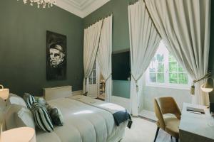 波尔图Torel Palace Porto的一间卧室设有一张大床和一个窗户。
