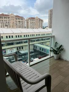 吉隆坡JULIE VILLA PLAZA DAMAS SUITES & RESIDENCES KUALA LUMPUR的享有大楼景致的阳台上的椅子