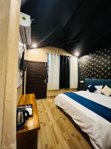 德拉敦The Bluewind Resort的一间卧室配有一张床和一部电话