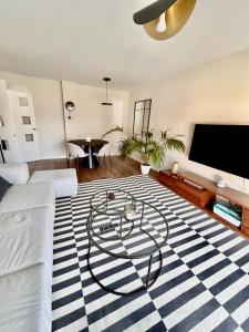 马德里Moderno apartamento inteligente的一间客厅,在条纹地毯上配有桌子