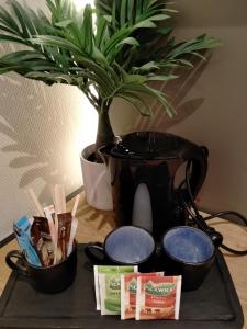 芬洛阿赫特芬洛住宿加早餐旅馆的桌上放有植物和锅的托盘