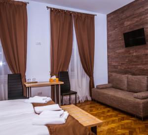锡比乌4Rooms Central Sibiu的酒店客房,配有床和沙发